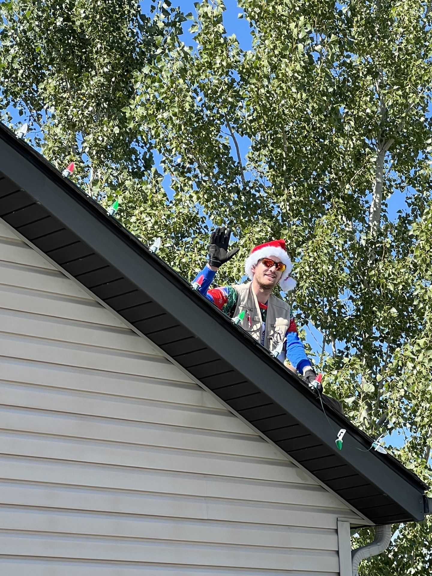 Santa's Magical Lights installer on a roofline